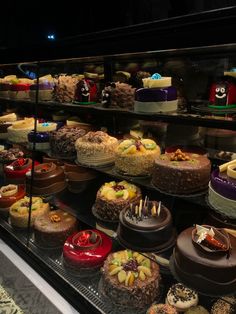 a display case filled with lots of different types of cakes