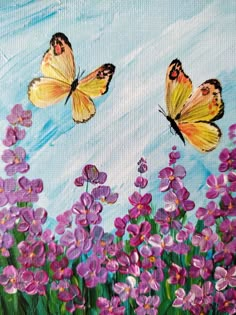 two butterflies are flying over purple flowers