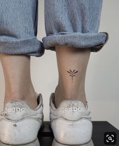 a person's foot with a small tattoo on their left ankle and the bottom part of her shoe