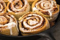 cinnamon rolls in a pan with icing drizzled on top