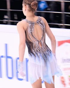 a female figure skating in a short dress