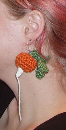 a woman with red hair wearing earrings made to look like a flower