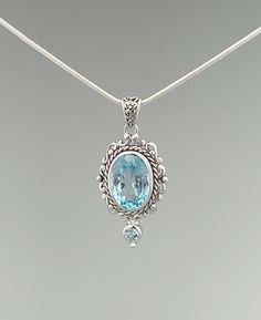 A large faceted blue topaz gemstone is housed inside a classic frame and further accented with a smaller blue topaz stone. Blue topaz is a calming stone associated with creativity and our inner truth. Sterling silver with premium rhodium plating Genuine blue topaz stones The pendant measures about 1.5" tall (including bail), and about 0.6" wide Sold as a pendant, the chain is sold separately Each stone is unique in its hues and tones About the Rhodium-Plated Sterling Silver: This design is made Blue Topaz Faceted Jewelry, Blue Gemstone Jewelry With White Topaz, Faceted Blue Topaz Jewelry, Elegant Large Blue Gemstone, Classic Light Blue Topaz Jewelry, Classic Blue Topaz Pendant Jewelry, Light Blue Topaz Jewelry With Gemstone Accents, Elegant Topaz Jewelry With Large Stone, Elegant Large Stone Topaz Jewelry