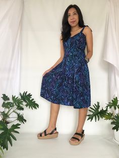 A rayon midi dress in blue and black color with floral and leaves pattern. Inspired by Bali scenery and the Balinese tradition that involving flowers in our daily routine such as for offerings.  This SLIP ON Midi dress has multiple elastic threads on the back of the dress to give you more size flexibility and the tie wrap on the shoulder makes an easy length adjustment.  2 front pocket in this casual short dress are conveniently to pump up your style with function of keeping your belongings in handy. Suit for casual, daily wear and holiday outfit.  Made of 100%  Rayon Batik with handmade batik process and traditional dyeing process. The color combinations and batik print placement are unique for each batch of productions, which make this dress one of kind casual dress.  If you need more de Casual Sleeveless Dress With Batik Print, Black Bohemian Sleeveless Dress With Floral Print, Blue Batik Print Sleeveless Dress, Blue Sleeveless Batik Print Dress, Blue Sleeveless Dress With Batik Print, Summer Midi Dress With Batik Print, Casual Blue Dress With Batik Print, Casual Black Dress With Batik Print, Casual Blue Rayon Sundress