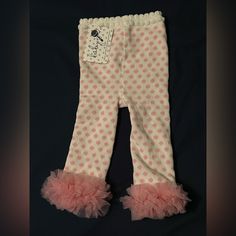 12-18 Month Pink And White Polka Dot Baby Leggings With Pink Ruffle Trim Around Ankles. New With Tags. 78% Cotton 2% Spandex 20% Polyester. Pink Ruffled Bottoms For Playwear, Cute Ruffled Bottoms For Playwear, Cute Ruffled Bottoms For Playtime, Spring Ruffled Bottoms For Playtime, Playful Stretch Ruffle Bottoms, Spring Playtime Ruffled Bottoms, Playful Stretch Bottoms With Ruffles, First Birthday Fitted Sets With Ruffles, White Ruffled Bottoms For Playwear