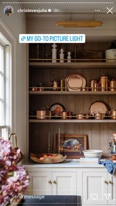 the shelves in this kitchen are filled with pots and pans