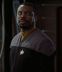 a man in a star trek uniform looking at the camera with an angry look on his face