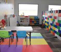 a child's playroom with multicolored tiles on the floor and walls