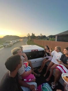 a group of people sitting in the back of a truck