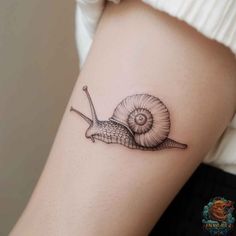 a snail tattoo on the arm