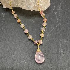 Faceted Morganite drop pendant is paired beautifully with Pink Topaz rosary style chain.The gorgeous faceted Morganite pendant has beautiful inclusions that help refract the light showing its inner sparkle. Combined with the Pink Topaz rosary style chain, make this a stunning necklace. The Pink Topaz stones have shades of light to darker pink with hints of yellow & peach. Finished off with lobster clasp and a gold filled dangle.Length: 16" with 2" extender.All jewelry comes packaged in gift box Rose Quartz Jewelry With Faceted Beads For Healing, Rose Quartz Teardrop Jewelry, Spiritual Drop Gemstone Crystal Necklace, Teardrop Necklace With Faceted Beads For Gift, Teardrop Faceted Bead Necklace For Gift, Gift Teardrop Faceted Bead Crystal Necklace, Spiritual Faceted Pendant Crystal Necklaces, Spiritual Faceted Pendant Crystal Necklace, Teardrop Gemstone Pendant For Jewelry Making