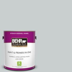 a can of behr premium plus paint and primer in one on a blue background