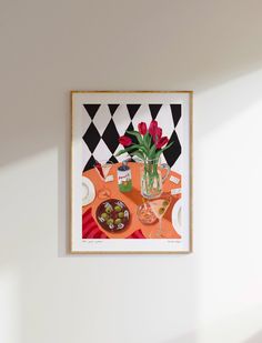 a vase filled with red flowers sitting on top of a table next to a plate