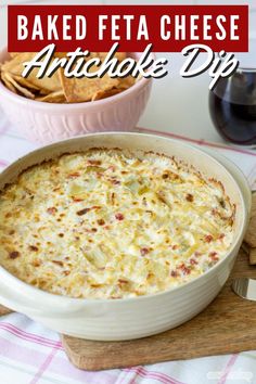 baked feta cheese artichoke dip in a white dish with crackers on the side