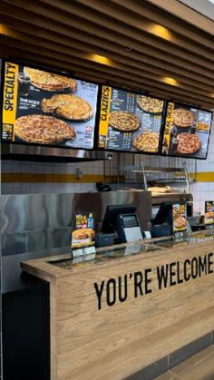 a pizza restaurant with menus on the wall and food in the front counter area