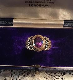 Superb 14k Solid Gold (stamped) Vintage (c1940s) Oval Amethyst Ring.  Ring is an elegant size at approx .5" tall, size 6.75-7.  Superb quality saturated color oval Amethyst set in 14k antiqued gold.  Lovely workmanship on sides of ring with swirling vine-like design.  Wonderful period piece!  Amethyst is the February birthstone.  Perfect gift for that special someone or treat yourself! *All gold jewelry is thoroughly tested with a GemOro Auracle Pro Digital Tester for gold content *All gemstones are digitally tested with a GemOro Ultratester +3 for authenticity Classic Purple Signet Ring For Anniversary, Vintage Engraved Rings For Formal Occasions, Heirloom Gold Amethyst Ring With Center Stone, Classic Purple Signet Ring For Formal Occasions, Classic Purple Rings For Formal Occasions, Purple Heirloom Ring For Formal Occasions, Vintage Hallmarked Engraved Ring For Formal Occasions, Art Deco Oval Engraved Ring For Formal Occasions, Classic Amethyst Birthstone Ring For Formal Occasions