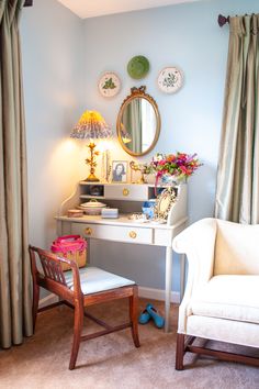 a bedroom with a desk, chair and mirror on the wall next to a window