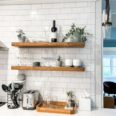 the shelves are filled with glassware and other kitchen items, including coffee mugs