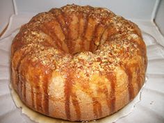 a bundt cake sitting on top of a white tablecloth covered counter next to a box