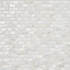 a white tile wall that looks like it has been made out of glass and marble