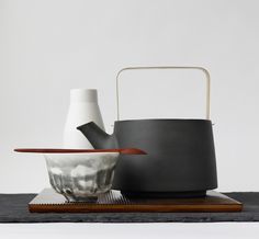 an assortment of vases and bowls on a table