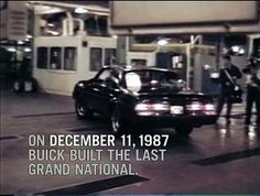 a black car driving down a street next to a gas station with the words on december 11, 1897 buick built the last grand national