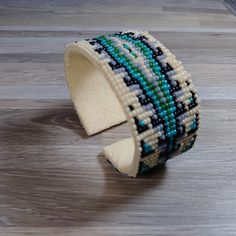 a close up of a bracelet on a wooden surface