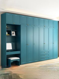 a bedroom with blue cabinets and a white rug