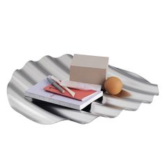 an egg, notebooks and pen on a plate