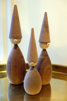 three wooden sculptures sitting on top of a table