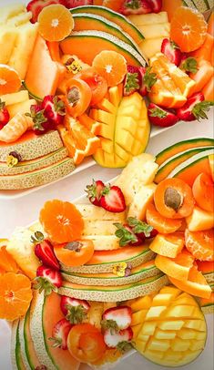 there are many slices of fruit arranged in the shape of an apple, oranges and melons