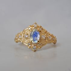 Step into a realm of ethereal beauty with our enchanting "Moonstone Moon Diamond" ring. This ring features a magical natural moonstone with a blue sheen when light reflects on it. Handcrafted in your choice of 14K and 18K gold. Only one available. All orders come in our Tippy Taste ring box. This ring is handmade and designed in NYC. 14K or 18K solid gold Natural oval moonstone. 6*4mm 12 Natural round diamonds. SI clarity, GH color, 0.11ct total carat weight 1.1mm width, 1.5mm thick band ** Tippy Taste Heirloom Collection is made to order. Please allow 3-4 week turnaround time. Shipping:Domestic: Free shippingInternational: Free shippingAll orders are insured, come with tracking, and with signature requirements. Please review our international shipping. Customization:- Interested in custom Moon Diamond Ring, Ethereal Beauty, Ring Box, 18k Rose Gold, Precious Metals, Moonstone, Round Diamonds, Solid Gold, Diamond Ring