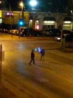 two people walking down the street at night