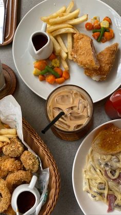 a table topped with plates of food and drinks