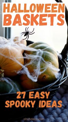 a basket full of halloween baskets with spider webs on the top and pumpkins in the bottom