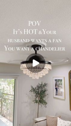 a living room with a chandelier hanging from the ceiling