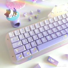 a computer keyboard sitting on top of a table next to some candy and candies