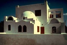 a large white building with arched windows and shutters