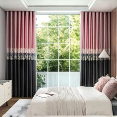 a bedroom with pink and black curtains, white bedding, and a large window