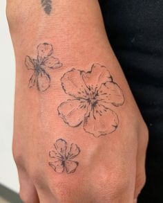 a person with a flower tattoo on their hand