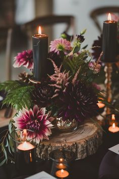 flowers and candles are sitting on a table