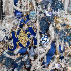 a blue and white christmas tree decorated with ornaments