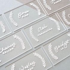 six clear place cards with white ink on them