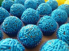 many blue cupcakes with sprinkles on them