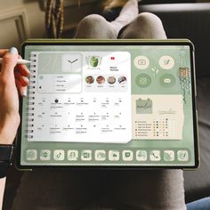 a person sitting on a couch holding up a laptop with the screen showing an app