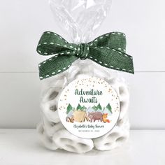 a bag filled with marshmallows sitting on top of a white table next to a green bow