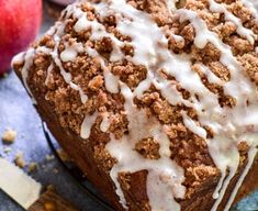 a loaf of bread with white icing and apples