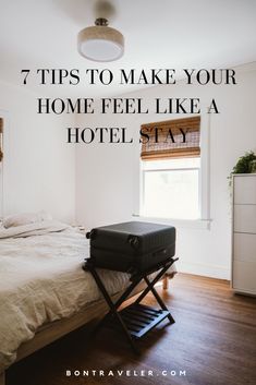 a hotel room with a bed and suitcase on the floor, text reads 7 tips to make your home feel like a hotel stay