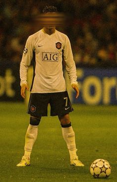 a man standing next to a soccer ball on a field