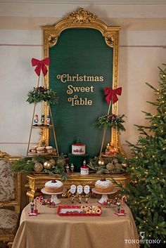 a christmas dessert table is set up in front of a green sign with the words christmas sweet table on it